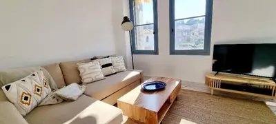 a living room with a couch and a flat screen tv at Bright Appartment perfect location in Saint-Jean-Cap-Ferrat