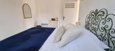 a bedroom with a large bed with blue sheets and pillows at Bright Appartment perfect location in Saint-Jean-Cap-Ferrat