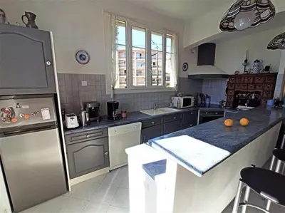 a kitchen with stainless steel appliances and a counter top at Villa tres proche du centre ville in Nice