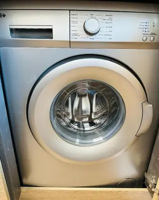 a close up of a washing machine at The NICE - 3 rooms, 3air cond, 3TV, 3fans, 2 wc, WIfi everywhere 5min aeroport, train, beach, 1min tram, 15 min centre, port, parking possible in Nice