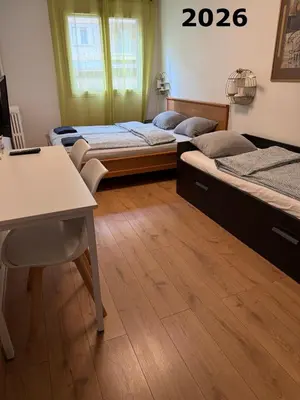 a room with three beds and a desk and a table at The NICE - 3 rooms, 3air cond, 3TV, 3fans, 2 wc, WIfi everywhere 5min aeroport, train, beach, 1min tram, 15 min centre, port, parking possible in Nice