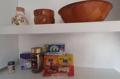a shelf with food and other items on it at Studio cosy à Nice in Nice