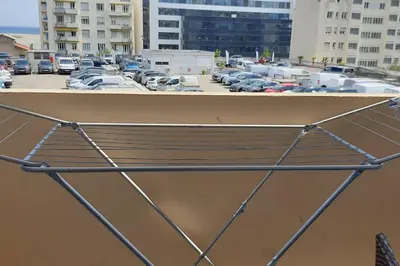 a bench in a parking lot with parked cars at Studio cosy à Nice in Nice