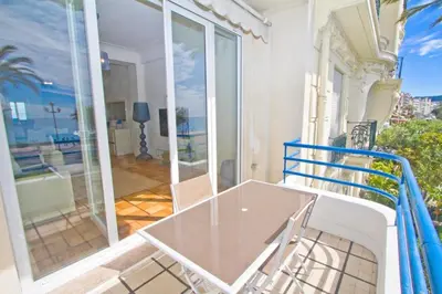 a glass table on the balcony of a house at Promenade des Anglais - Sea View 2bdr in Nice