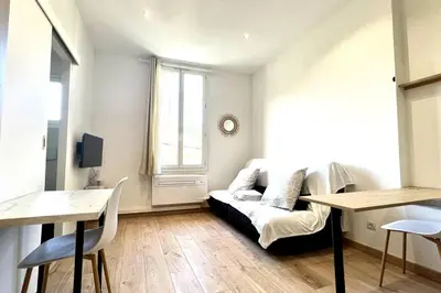 a living room with a couch and a table at LE RAPHAEL - Studio à 10 min de la mer - Wifi et Climatisation in Nice