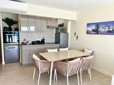 a kitchen and dining room with a table and chairs at SEA FRONT View Top Roof Flat in Nice
