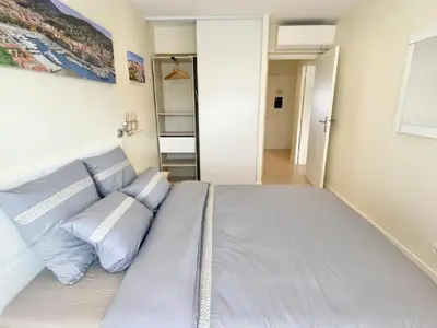 a large bed with blue pillows in a bedroom at SEA FRONT View Top Roof Flat in Nice