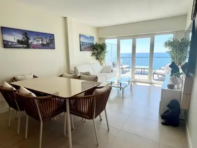 a living room with a table and chairs and the ocean at SEA FRONT View Top Roof Flat in Nice