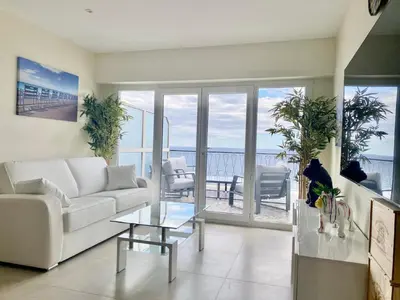 a living room with a white couch and a glass table at SEA FRONT View Top Roof Flat in Nice