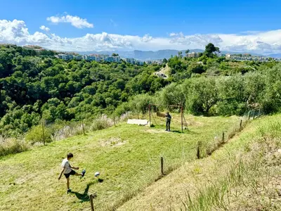 two people playing a game of soccer on a field at Villa SYAGRUS - Easy Home Booking in Nice