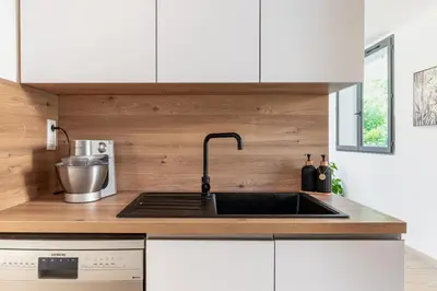 a kitchen with a sink and white cabinets at Villa Summertime in Nice