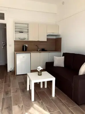 a living room with a couch and a table at Studio refait neuf Centre-ville in Nice