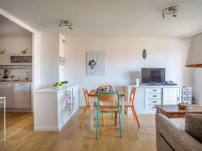 a kitchen and living room with a table and chairs at Apartment Le Lagon Bleu by Interhome in Cagnes-sur-Mer