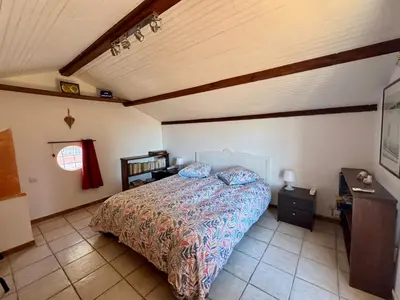 a bedroom with a bed in a room at Chambre d'hôtes duplex Le petit mas niçois de la Villa rose in Nice