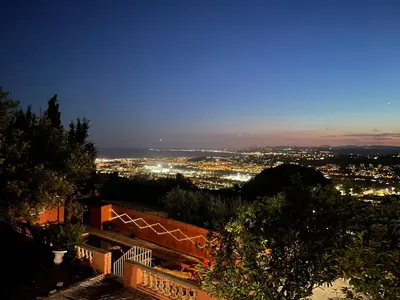 a view of a city at night at Chambre d'hôtes duplex Le petit mas niçois de la Villa rose in Nice