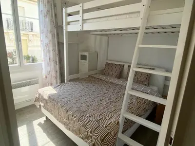 a bedroom with two bunk beds and a window at Central Rossini Flat with Balcony in Nice