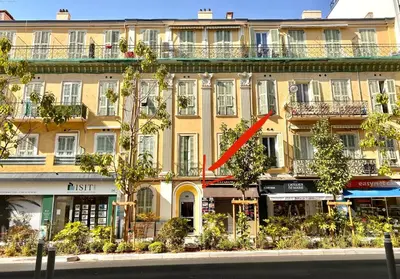 a building with a red arrow on the side of it at Petit cocon en duplex - Centre-ville & plage à 2 minutes in Nice