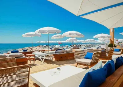 a group of chairs and umbrellas on a beach at Petit cocon en duplex - Centre-ville & plage à 2 minutes in Nice