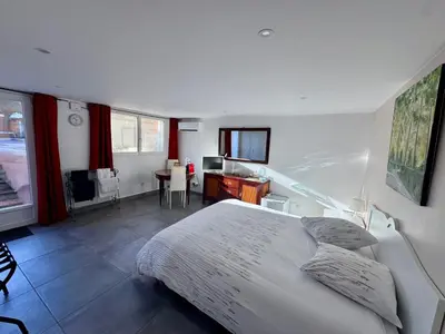 a bedroom with a large white bed and a desk at Chambre d'hôtes A l'ancre marine de la Villa Rose in Nice