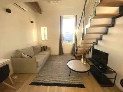 a living room with a couch and a staircase at Lamartine hypercentre 503 in Nice