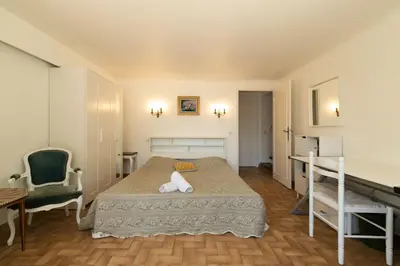 a bedroom with a bed and a table and a desk at Maison Bianchi - Villa Saint Pierre de Feric in Nice