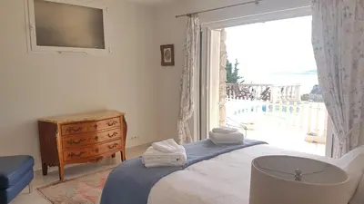 a bedroom with a bed and a large window at Roc Maria Lucia in Nice