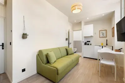 a living room with a green couch and a table at Residence Massena in Nice