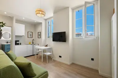 a living room with a couch and a table at Residence Massena in Nice