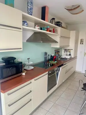 a kitchen with white cabinets and a microwave at Front sea Luxury in Cagnes-sur-Mer