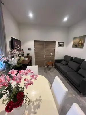 a living room with a couch and a table with flowers at appartement nice in Nice