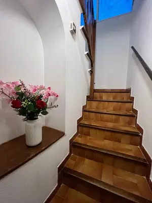 a staircase with a vase of flowers on a shelf at appartement nice in Nice