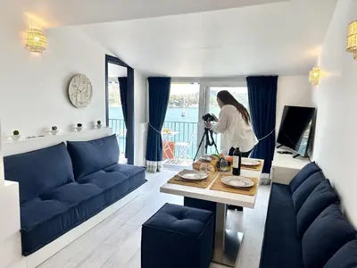 a woman taking a picture of a living room at MAISON BLEUE AP4362 By Riviera Holiday Homes in Villefranche-sur-Mer