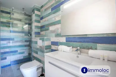 a bathroom with a white sink and a toilet at Air-conditioned studio 5 minutes from the beach and shops in Cros-de-Cagnes