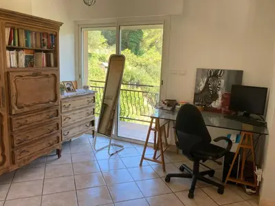 a room with a desk with a computer and a chair at Villa avec piscine et vue magnifique sur Nice in Nice