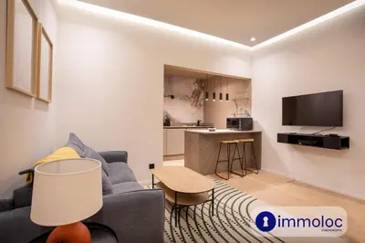 a living room with a couch and a kitchen at Air-conditioned apartment in Old Nice in Nice