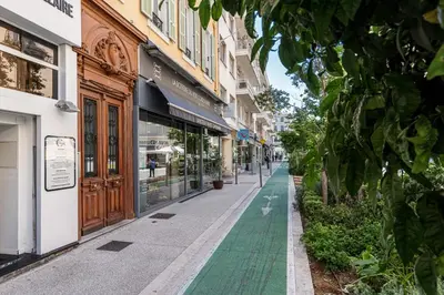 a street in a city with a green sidewalk at Charming Central 1 Bdr in Nice