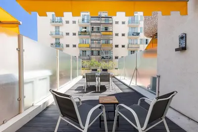 a balcony with chairs and a table on a building at 1 Bdr Large Terrace in Nice
