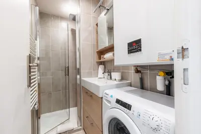 a small bathroom with a washing machine and a sink at 1 Bdr Large Terrace in Nice