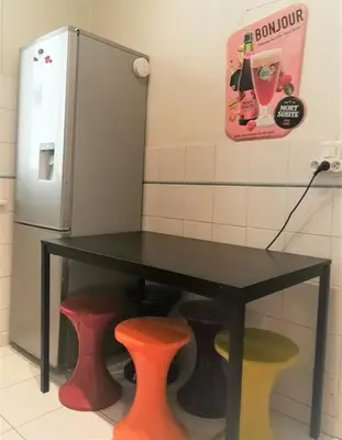 a black table with two stools and a drink dispenser at Appartement 110m2 Nice plein centre in Nice