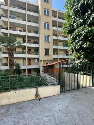a fence in front of a large apartment building at Suite Gloria Five stars holiday house in Nice