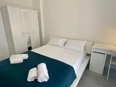 a small bedroom with a bed with towels on it at Suite Gloria Five stars holiday house in Nice