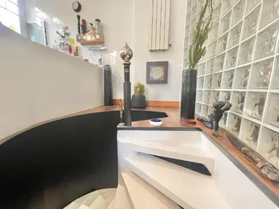 a room with a counter with a shelf with wine glasses at Souvenir à jamais ! in Nice