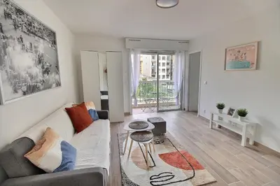 a living room with a couch and a table at Cosy appartement en plein coeur de la libération in Nice