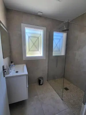 a bathroom with a shower and a sink and a window at Nice, Magnifique villa vue mer avec piscine in Nice