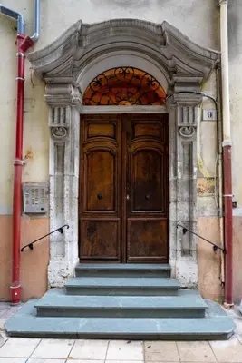 an old wooden door with stairs in front of a building at 06A4 - Situation exceptionnelle au Port de Nice in Nice