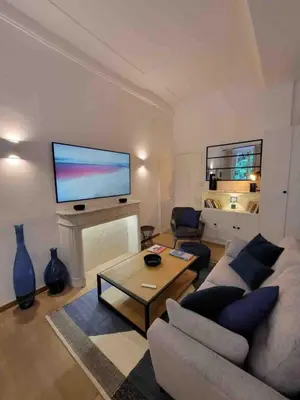 a living room with a couch and a large screen tv at 06A4 - Situation exceptionnelle au Port de Nice in Nice