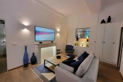 a living room with a couch and a tv on a wall at 06A4 - Situation exceptionnelle au Port de Nice in Nice
