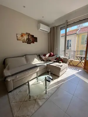 a living room with a couch and a glass coffee table at The entire apartment 2 rooms, Balcony, Sea view in Nice