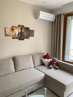 a teddy bear sitting on a couch in a living room at The entire apartment 2 rooms, Balcony, Sea view in Nice