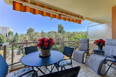 a patio with a table and chairs and a balcony at Happyfew Sainte Anne in Nice